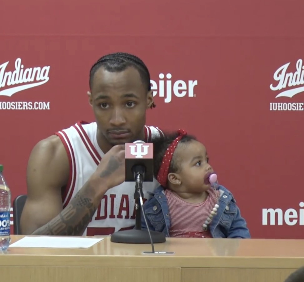 Indiana sophomore guard Tamar Bates answers questions at the postgame press conference with his daughter Leilani, who won the halftime baby race on Sunday at Simon Skjodt Assembly Hall in Bloomington, Ind.