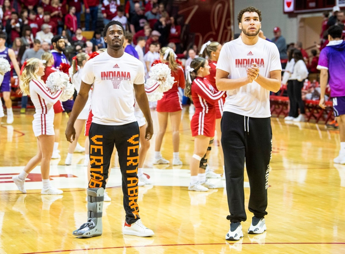 Indiana's Xavier Johnson (left) and Race Thompson (right) watch the Hoosiers during warm-ups before the first half of the Indiana versus Northwestern men's basketball game at Simon Skjodt Assembly Hall on Sunday, Jan. 8, 2023.