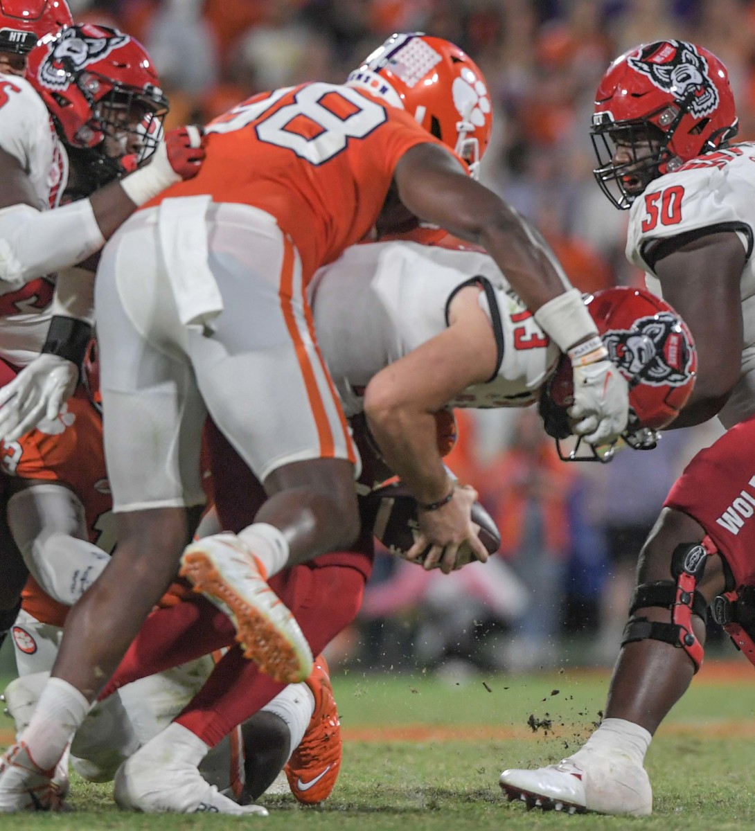 Clemson defensive end Myles Murphy (98) sacks NC State quarterback Devin Leary (13) during the fourth quarter at Memorial Stadium in Clemson, South Carolina Saturday, October 1, 2022. Ncaa Football Clemson Football Vs Nc State Wolfpack