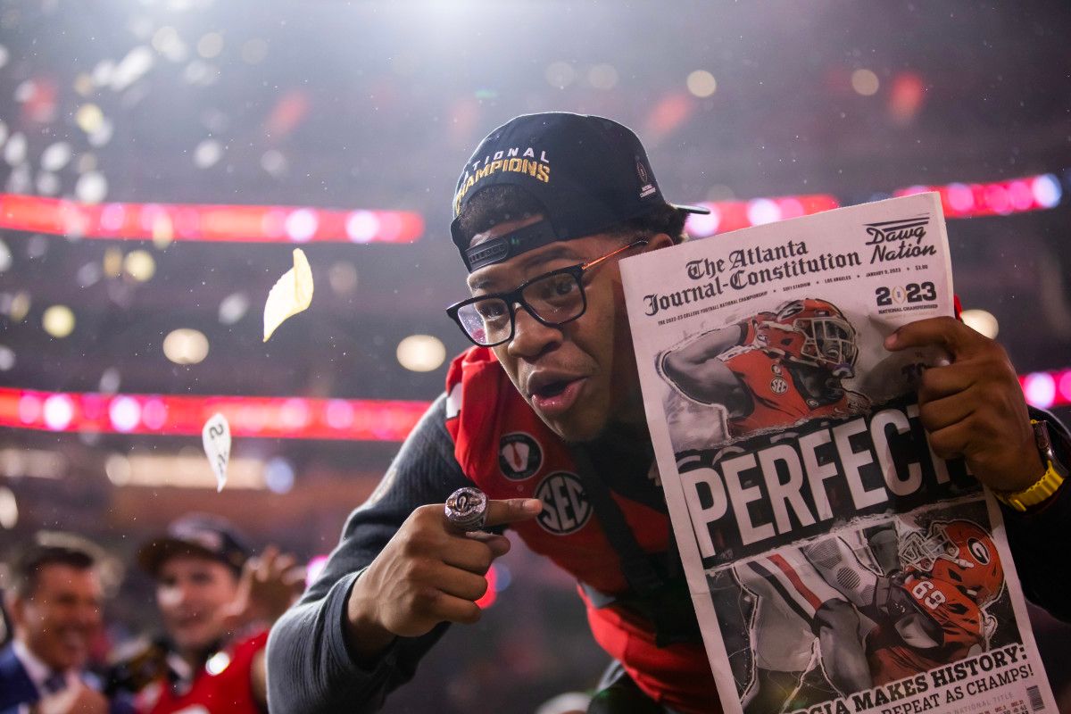 Georgia Bulldogs linebacker Nolan Smith (4) celebrates with the championship trophy after defeating the TCU Horned Frogs during the CFP national championship game at SoFi Stadium.