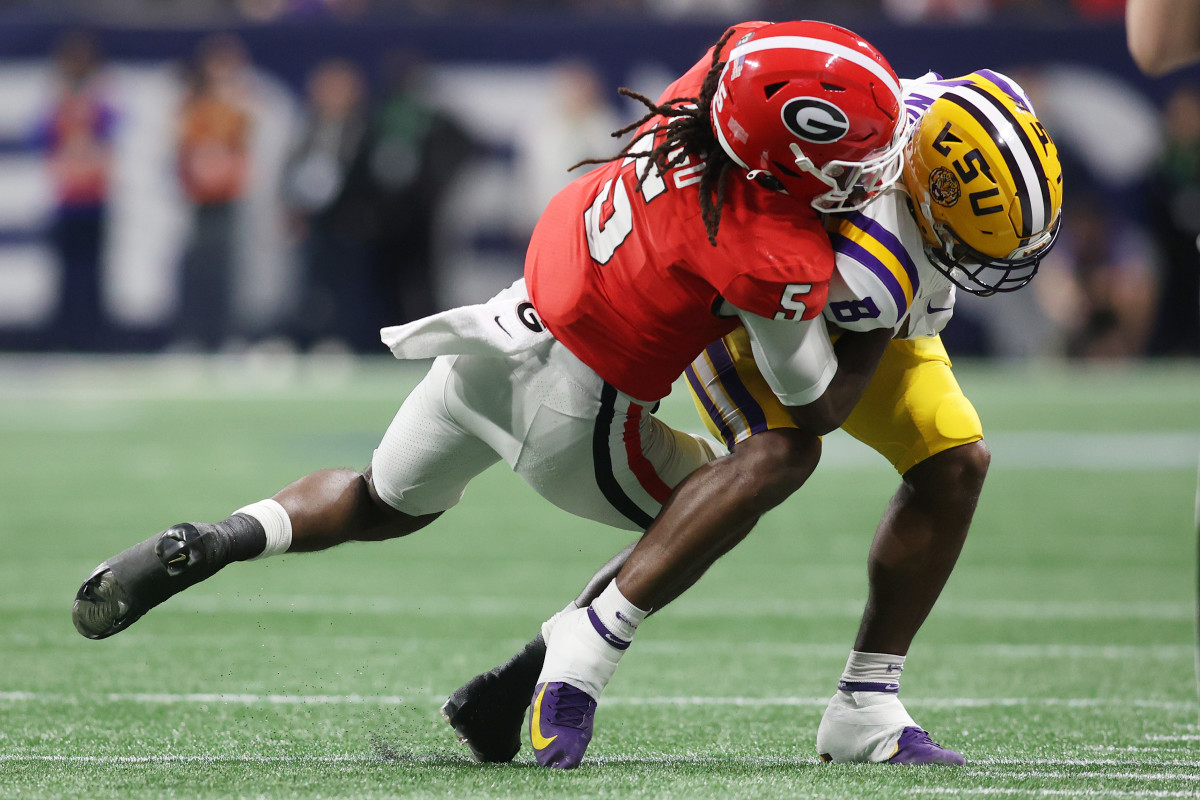 Dec 3, 2022; Atlanta, GA, USA; LSU Tigers wide receiver Malik Nabers (8) is hit after his reception by Georgia Bulldogs defensive back Kelee Ringo (5) during the first quarter at Mercedes-Benz Stadium.