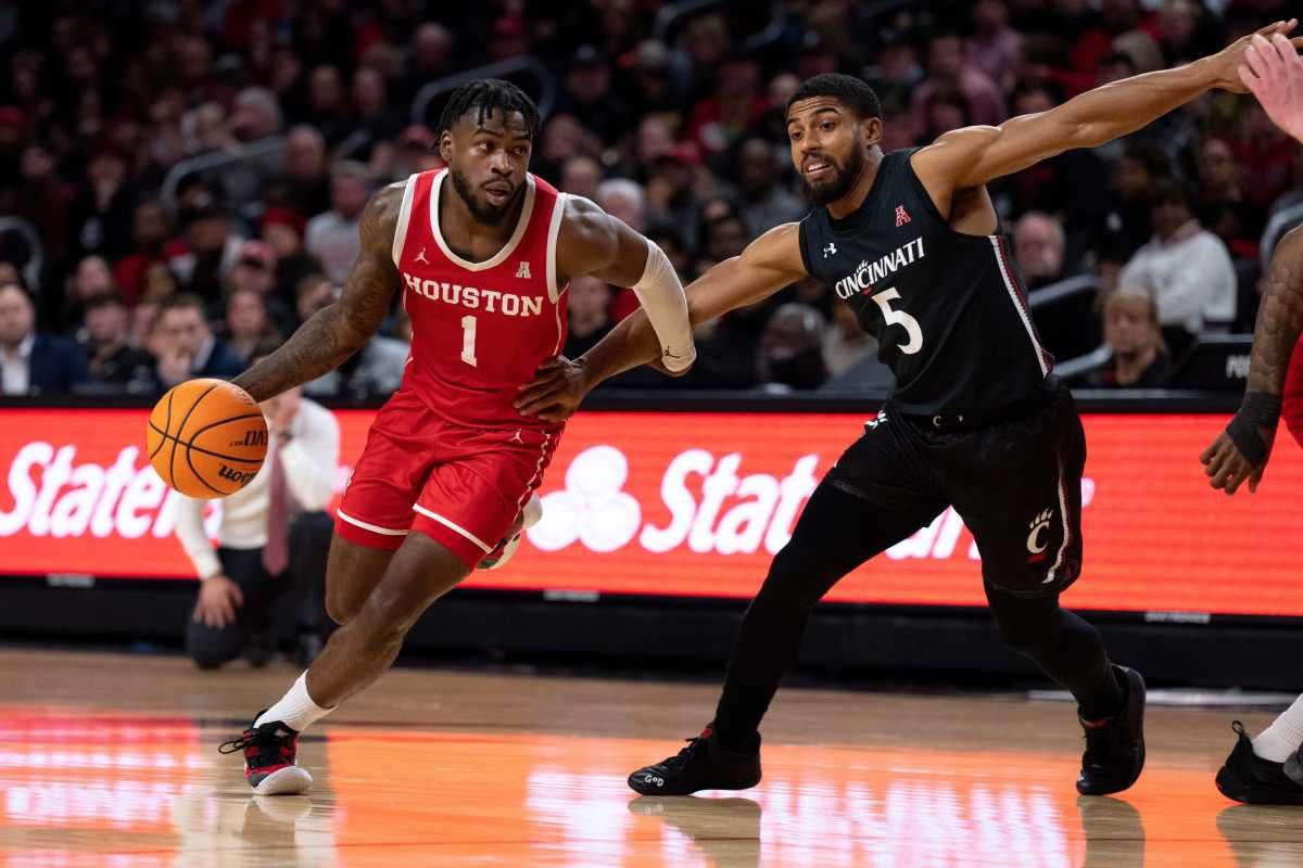 Houston Cougars guard Jamal Shead (1) drives on Cincinnati Bearcats guard David DeJulius (5) in the second half of the NCAA men s basketball game at Fifth Third Arena in Cincinnati on Sunday, Jan. 8, 2023. Houston Cougars defeated Cincinnati Bearcats 72-59. Ncaa Basketball Houston Cougars At Cincinnati Bearcats