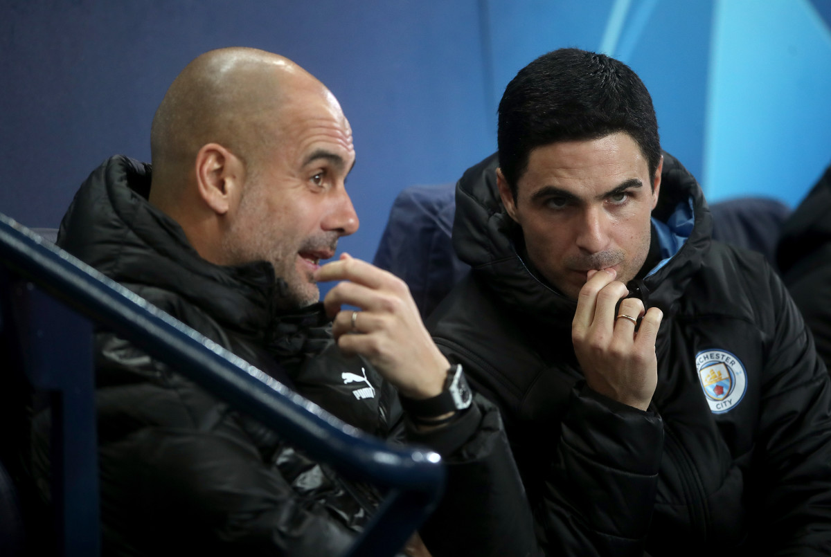 Pep Guardiola (left) and Mikel Arteta pictured in the Manchester City dugout during a game in November 2019