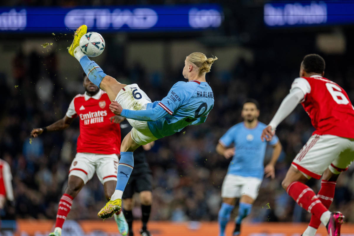 Erling Haaland pictured shooting with an overhead kick during an FA Cup game between Manchester City and Arsenal in 2023