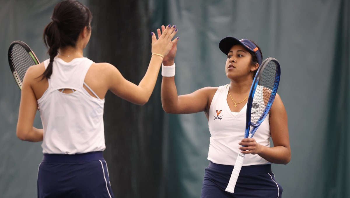 Annabelle Xu and Natasha Subhash celebrate after a point during doubles play in the Virginia women's tennis match against Richmond at Boar's Head Sports Club.
