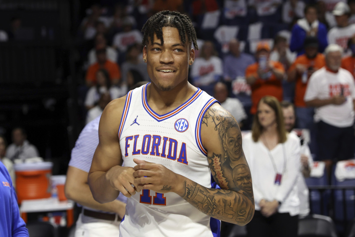 Florida forward Keyontae Johnson (11) smiles after being introduced as a starter before the first half of an NCAA college basketball game against Kentucky, on March 5, 2022, in Gainesville, Fla. Johnson was the Southeastern Conference’s preseason player of the year in 2020-21 but collapsed during a game in December 2020 and hasn’t played since.