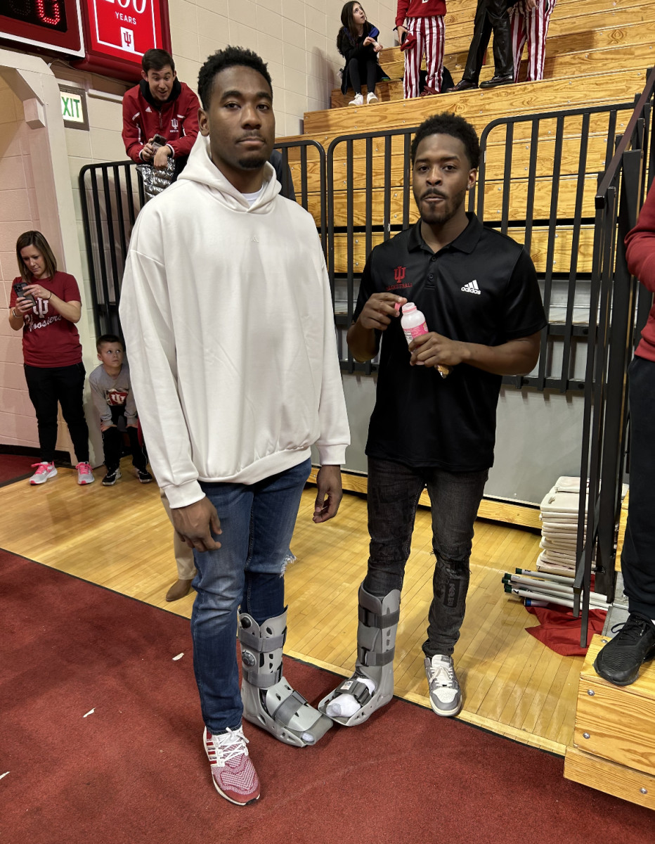 Indiana forward Jordan Geronimo (left) and point guard Xavier Johnson (right) wearing walking boots prior to Saturday's game against Ohio State at Simon Skjodt Assembly Hall. Sophomore center Logan Duncomb is also out with a non-COVID illness.