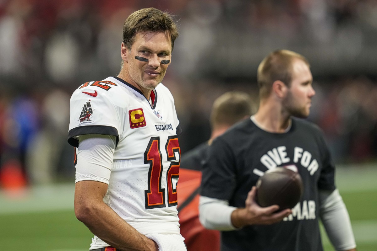 Tom Brady smiles during pre-game warmups before a Bucs-Falcons game in January
