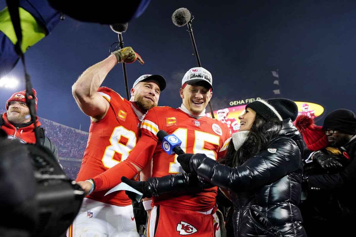 Travis Kelce shouts encouragement behind Patrick Mahomes during a post-game interview