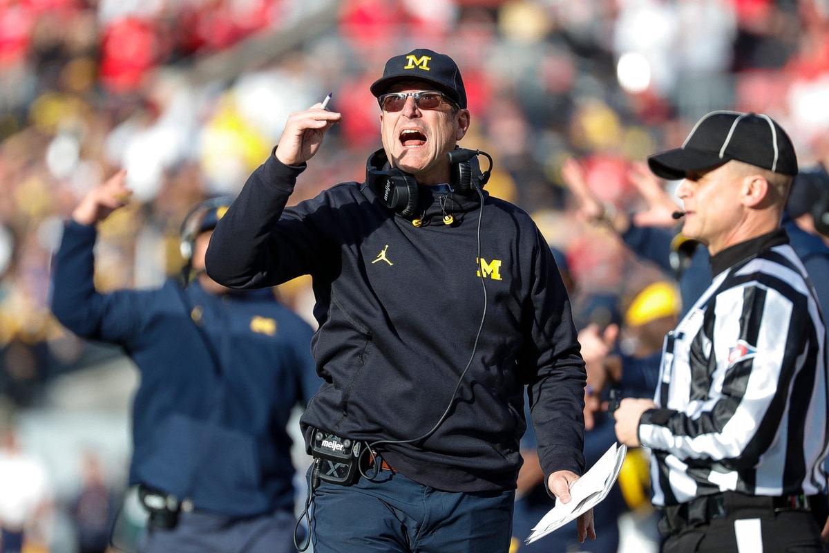 The Broncos remain interested in Michigan coach Jim Harbaugh.