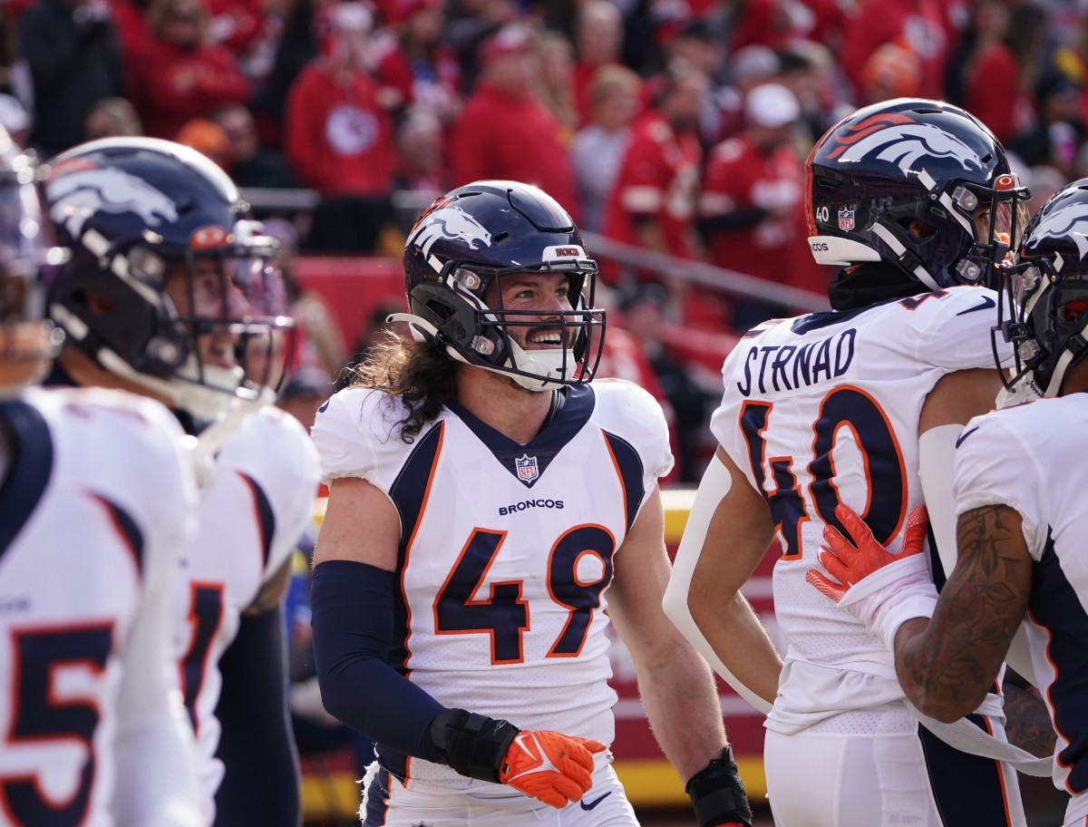 Jan 1, 2023; Kansas City, Missouri, USA; Denver Broncos linebacker Alex Singleton (49) celebrates with team mates after a fumble recovery against the Kansas City Chiefs during the first half at GEHA Field at Arrowhead Stadium.