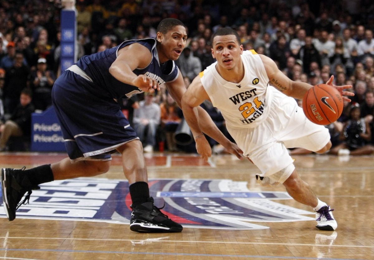 Mar 13, 2010; New York, NY, USA; West Virginia Mountaineers guard Joe Mazzulla (21) drives past Georgetown Hoyas forward Jerrelle Benimon (20) in the 2nd half of the 2010 mens Big East Tournament championship game at Madison Square Garden.