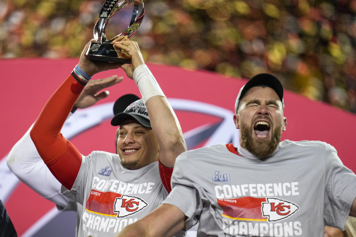Kansas City Chiefs quarterback Patrick Mahomes raises the Lamar Hunt Trophy with tight end Travis Kelce yelling next to him after the AFC championship NFL game