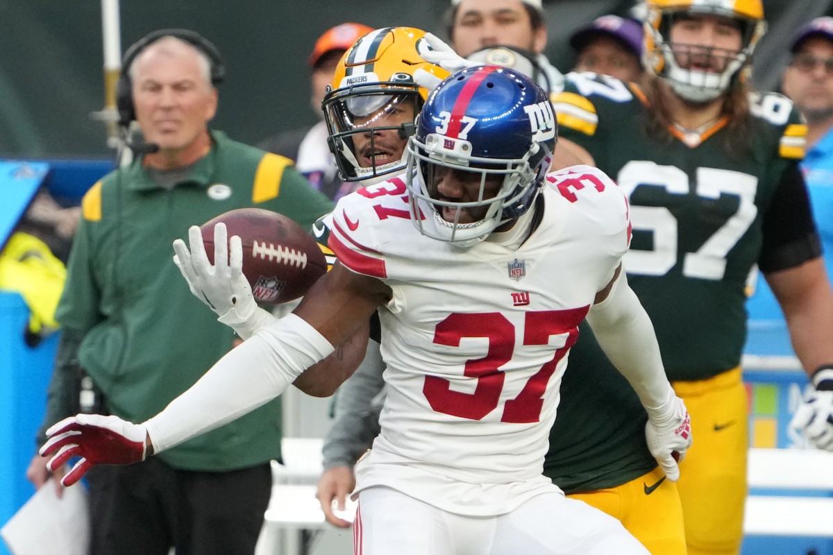 Oct 9, 2022; London, United Kingdom; New York Giants cornerback Fabian Moreau (37) defends against Green Bay Packers wide receiver Allen Lazard (13) in the second half during an NFL International Series game at Tottenham Hotspur Stadium. Mandatory Credit: Kirby Lee-USA TODAY Sports