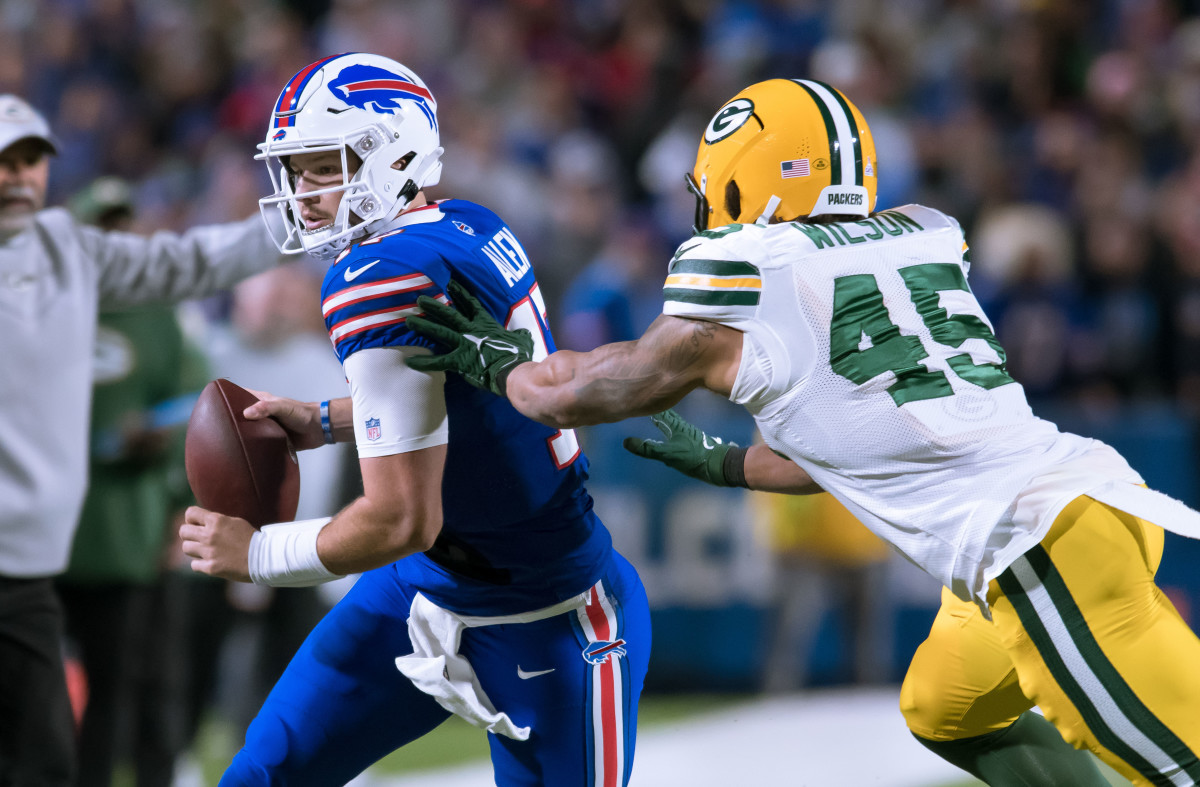 Oct 30, 2022; Orchard Park, New York, USA; Buffalo Bills quarterback Josh Allen (17) is forced out of bounds by Green Bay Packers linebacker Eric Wilson (45) in the second quarter at Highmark Stadium. Mandatory Credit: Mark Konezny-USA TODAY Sports