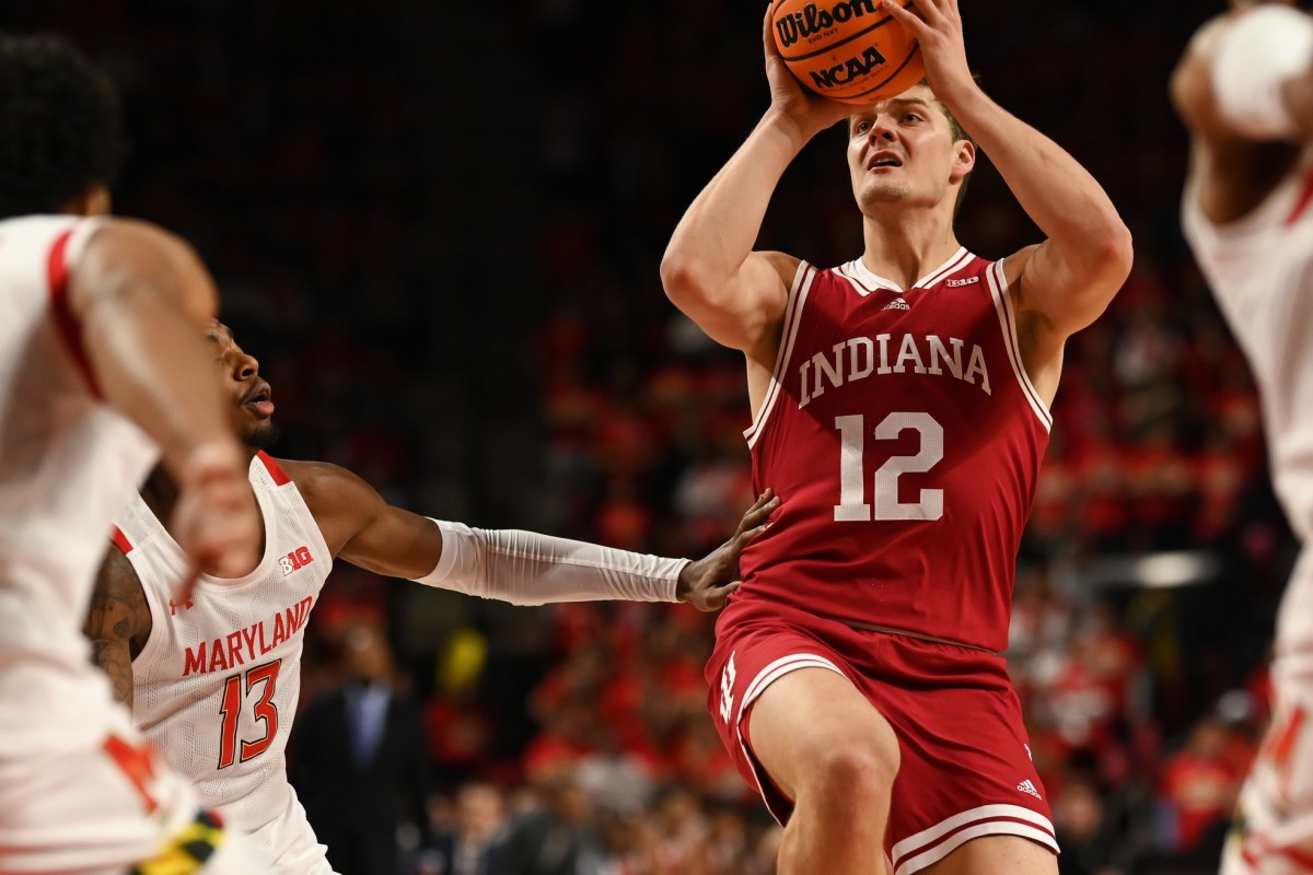 Indiana forward Miller Kopp (12) looks to pass to the middle as Maryland Terrapins guard Hakim Hart (13) defends during the first half at Xfinity Center.
