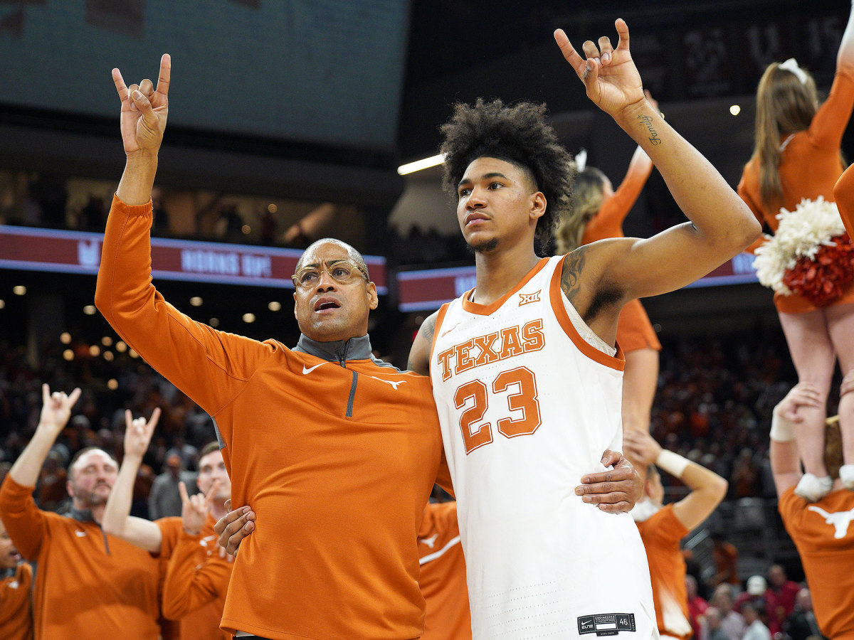 Texas’s Rodney Terry and Dillon Mitchell give a Horns Up gesture