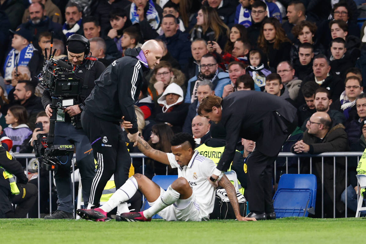Eder Militao pictured being helped up from the ground after sustaining an injury during Real Madrid's 2-0 win over Valencia in February 2023
