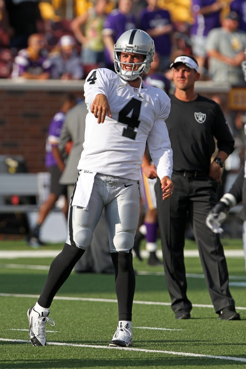 Aug 8, 2014; Oakland Raiders quarterback Derek Carr (4) is watched by head coach Dennis Allen in pregame drills. Mandatory Credit: Brace Hemmelgarn-USA TODAY Sports