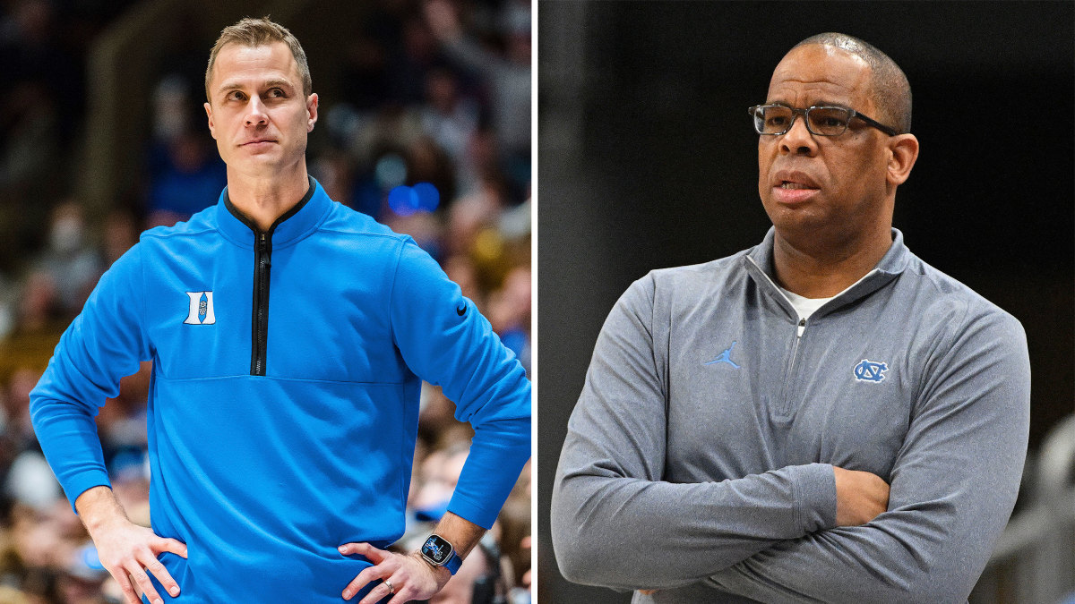 Duke’s Jon Scheyer and UNC’s Hubert Davis stand with their arms crossed