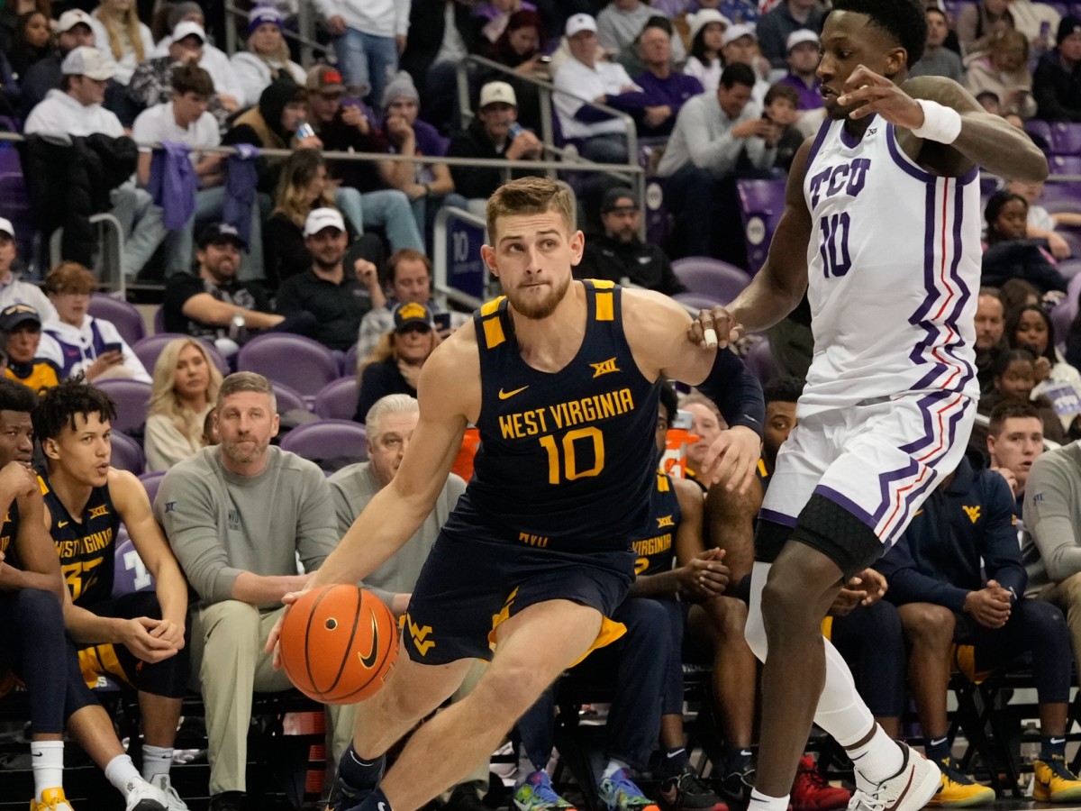 Jan 31, 2023; Fort Worth, Texas, USA; West Virginia Mountaineers guard Erik Stevenson (10) drives to the basket past TCU Horned Frogs guard Damion Baugh (10) during the second half at Ed and Rae Schollmaier Arena.