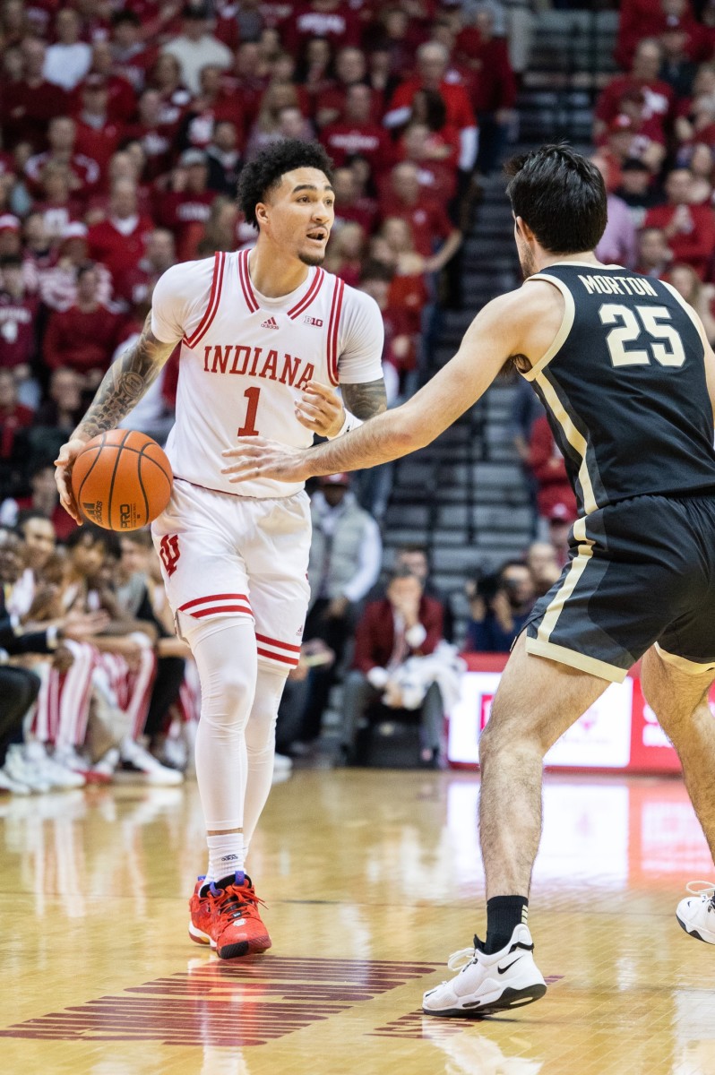 Jalen Hood-Schifino (1) dribbles the ball while Purdue Boilermakers guard Ethan Morton (25) defends.