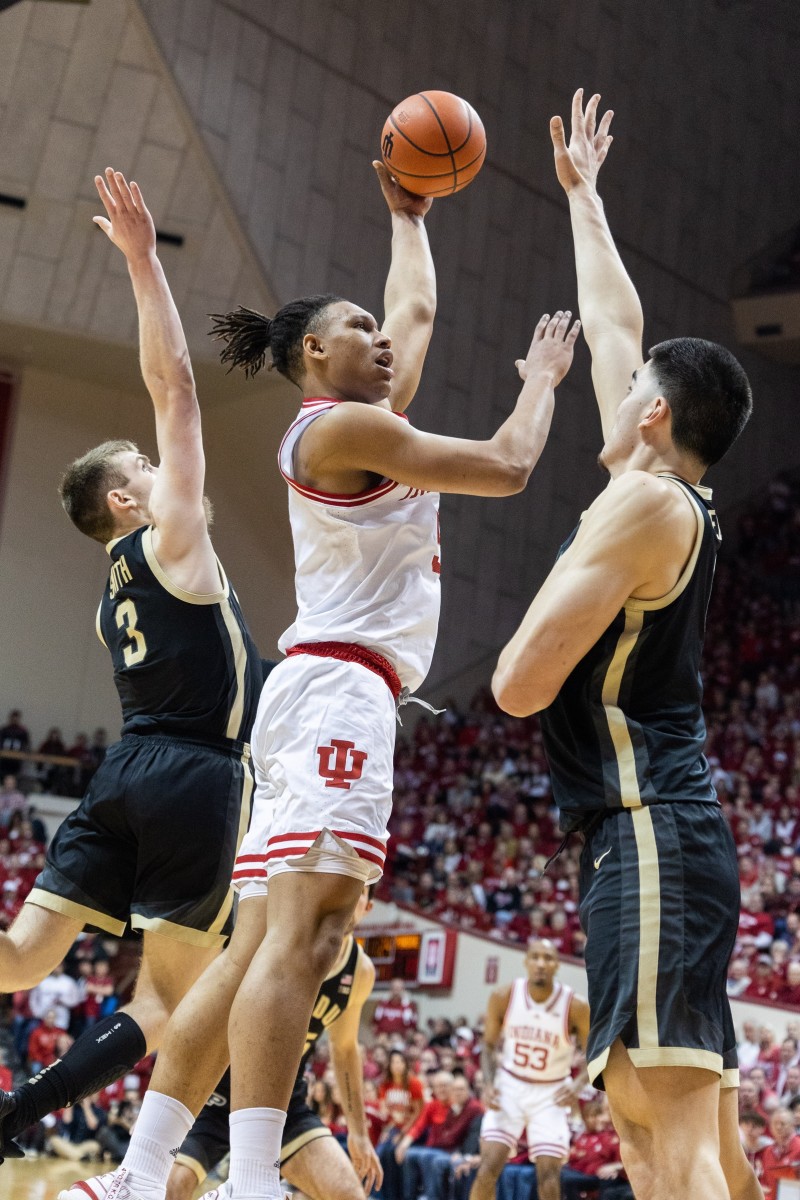 Indiana forward Malik Reneau (5) shoots the ball while Purdue center Zach Edey (15) and guard Braden Smith (3) defend.