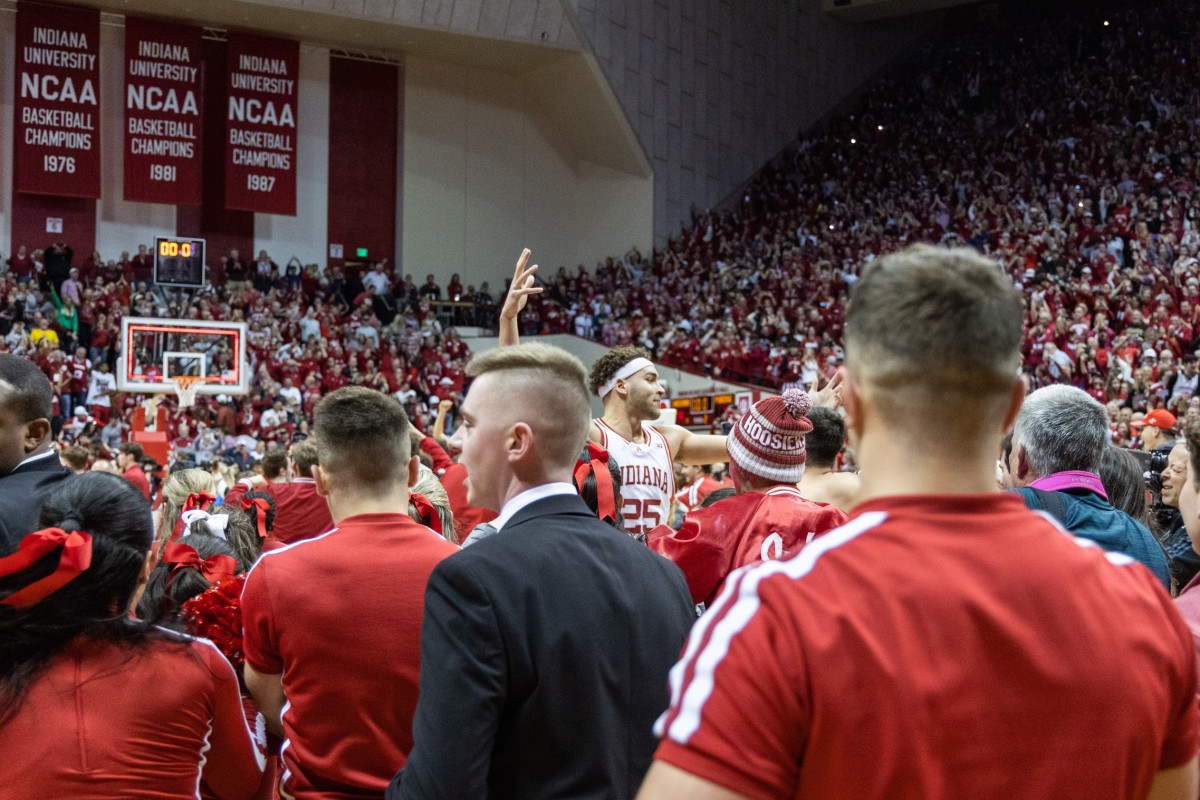 Race Thompson (25) in the middle of the fans rushing the court after the game against the Purdue.