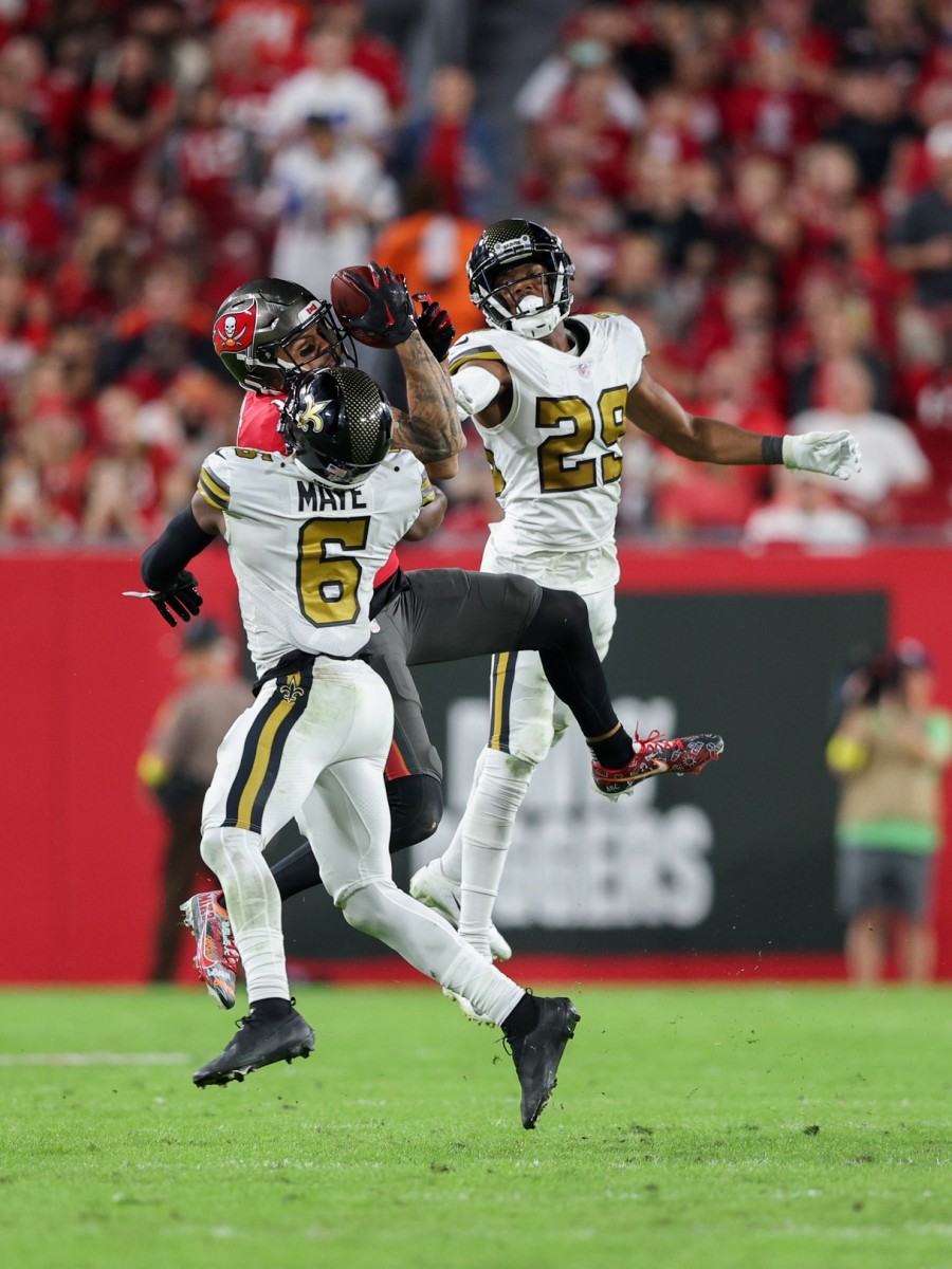 Tampa Bay Buccaneers receiver Mike Evans (13) catches a pass defended by New Orleans Saints safety Marcus Maye (6) and cornerback Paulson Adebo (29). Mandatory Credit: Nathan Ray Seebeck-USA TODAY