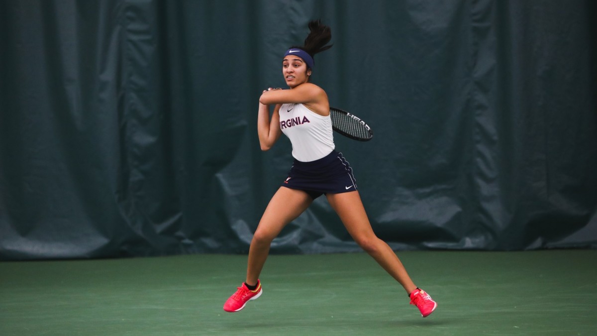Hibah Shaikh competing in singles action during the Virginia women's tennis match against William & Mary at Boar's Head Sports Club.