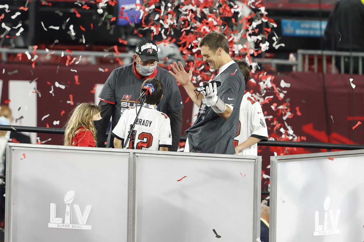Tampa Bay Buccaneers quarterback Tom Brady celebrates with family member as confetti falls around them