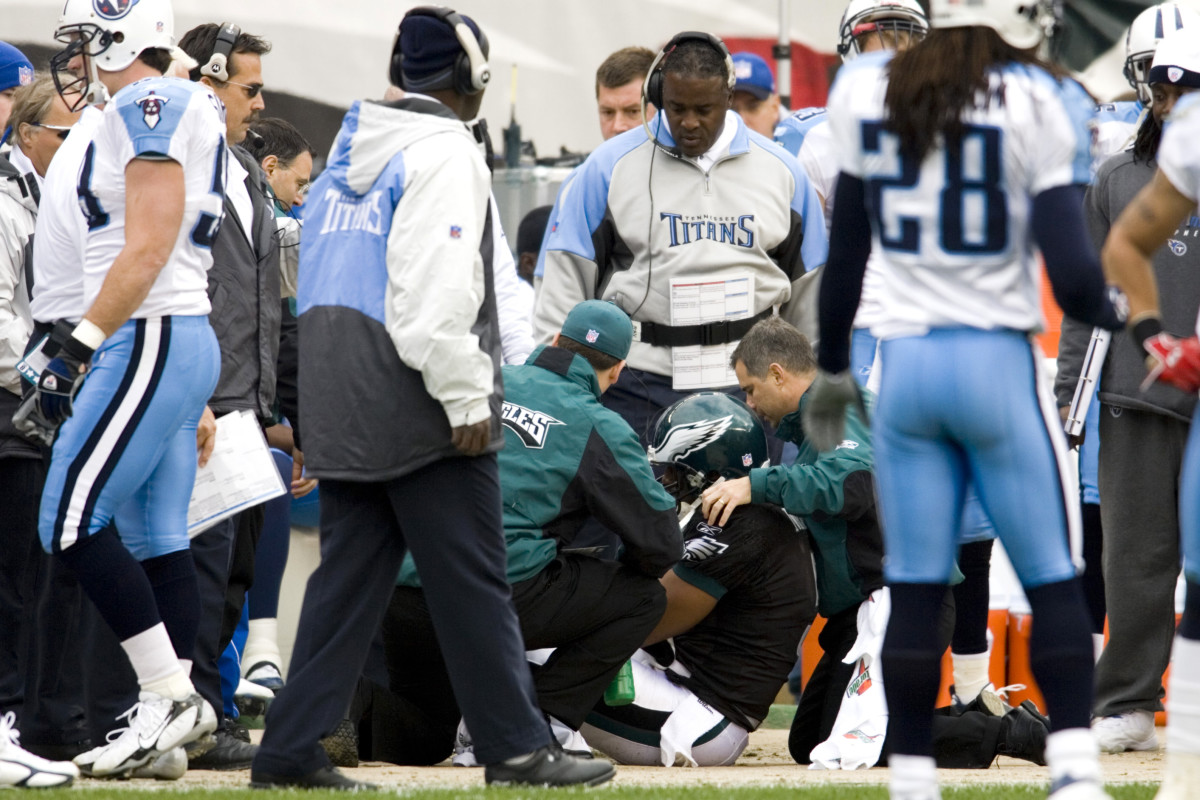 Trainers tend to Eagles QB Donovan McNabb after an injury near the Titans sideline