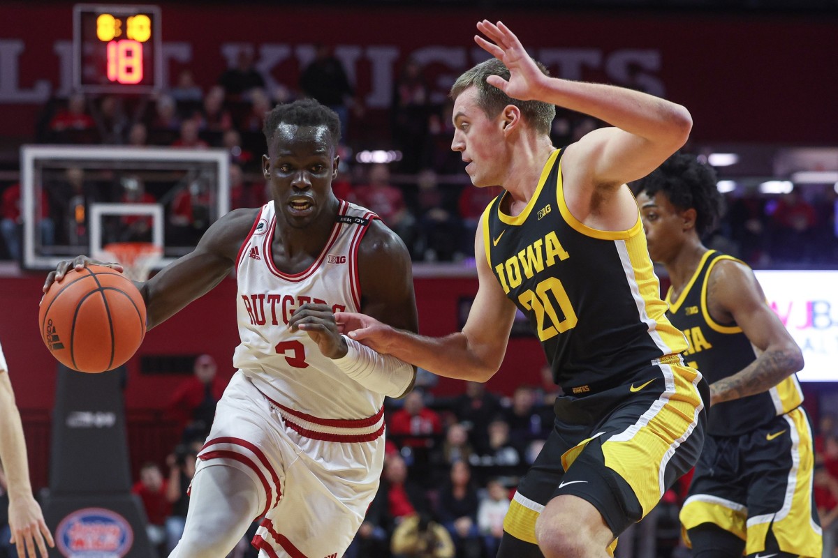 Rutgers Scarlet Knights forward Mawot Mag (3) drives to the basket as Iowa Hawkeyes forward Payton Sandfort (20) defends during the first half at Jersey Mike's Arena.