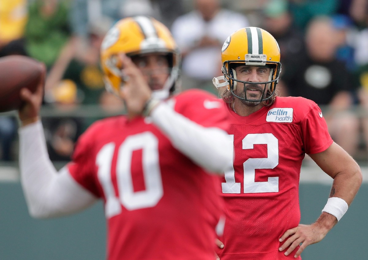 Packers starting quarterback Aaron Rodgers watches Jordan Love, who could replace Rodgers this offseason.