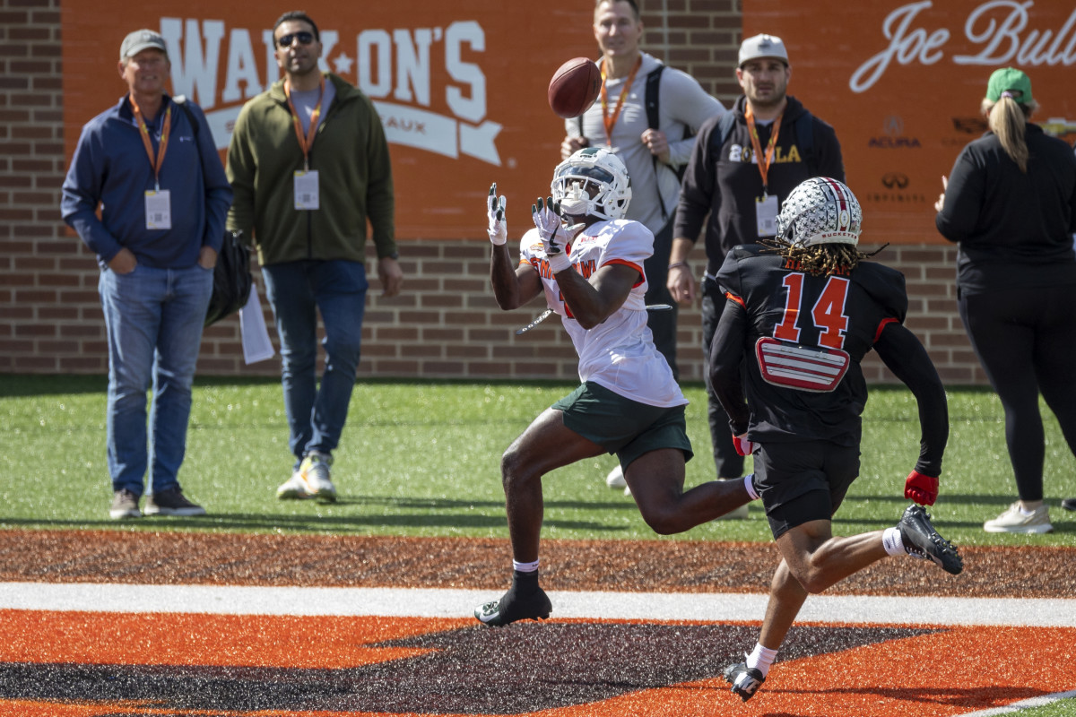 Jayden Reed of Michigan State (1) makes a catch in the end zone ahead of Ronnie Hickman of Ohio State during Senior Bowl practices. (Photo by Vasha Hunt-USA TODAY Sports)