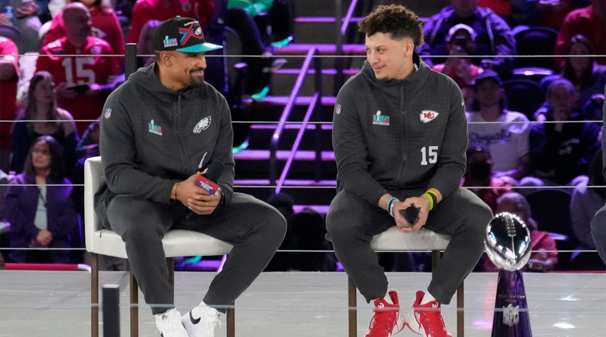 Philadelphia Eagles quarterback Jalen Hurts and Kansas City Chiefs quarterback Patrick Mahomes chat on stage during Super Bowl Opening Night on Feb. 6, 2023, at the Footprint Center in downtown Phoenix.