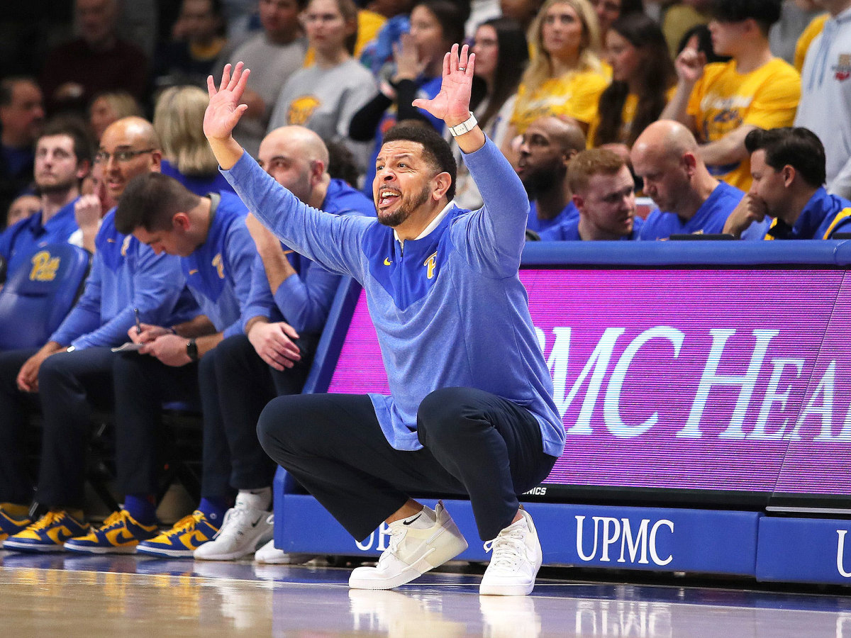 Jeff Capel holds up his arms on the Pitt sideline