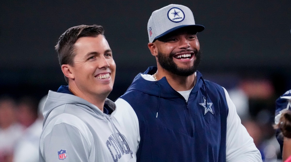 Cowboys quarterback Dak Prescott (right) laughs with offensive coordinator Kellen Moore before a game against the Giants.