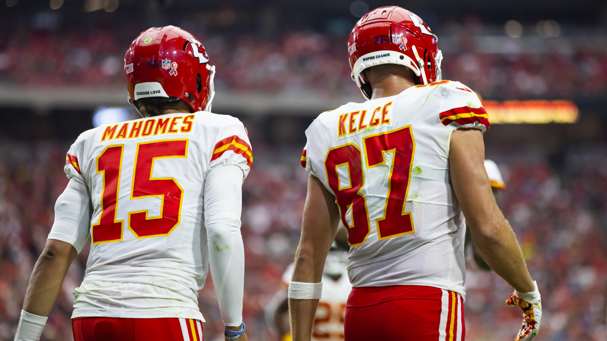 Mahomes and Kelce walk onto the field during a Chiefs game