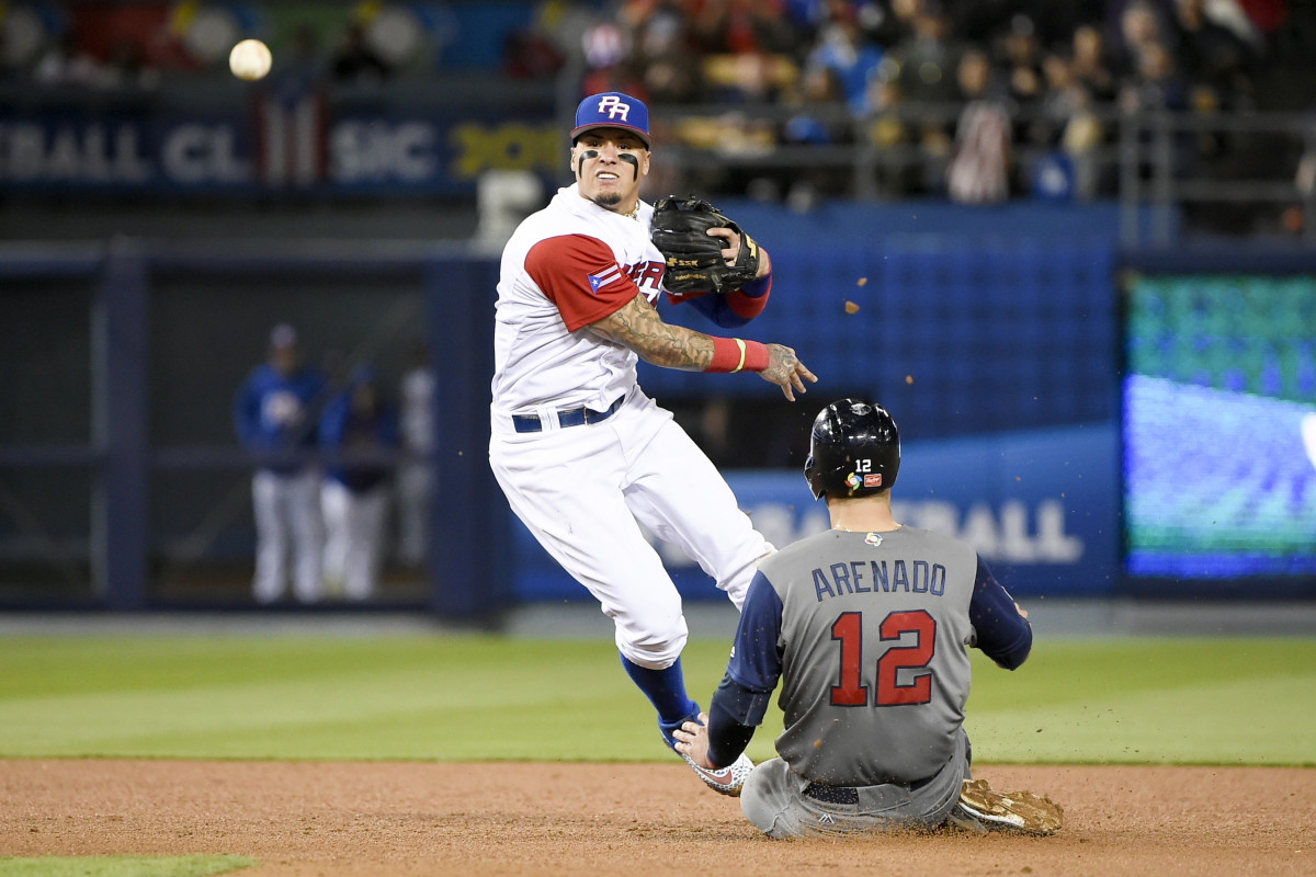 Puerto Rico second baseman Javier Baez throws to first after getting out United States third baseman Nolan Arenado during the fifth inning of the 2017 World Baseball Classic at Dodger Stadium.
