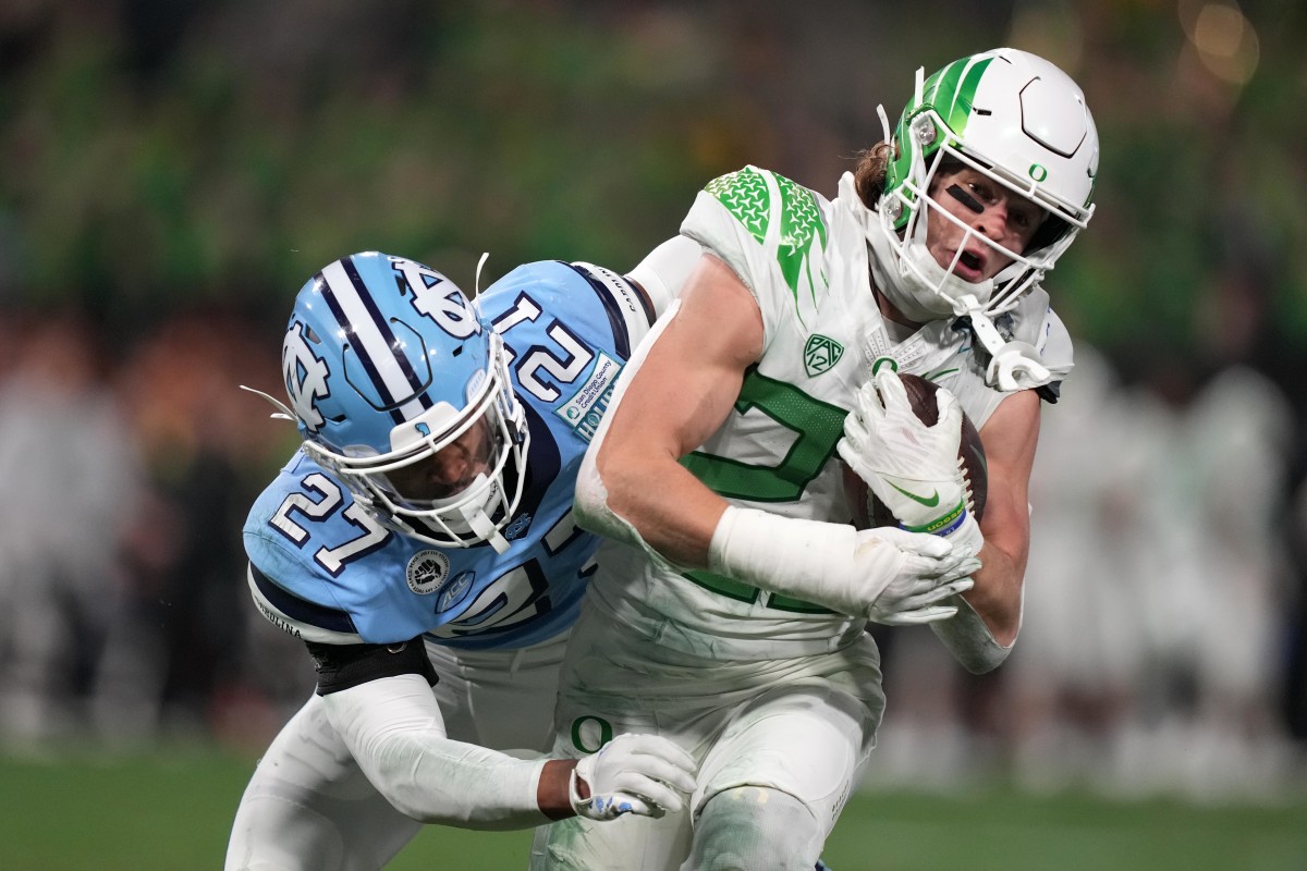 Oregon Ducks wide receiver Chase Cota (23) carries the ball against North Carolina Tar Heels linebacker Power Echols (23) during the fourth quarter of the 2022 Holiday Bowl at Petco Park.