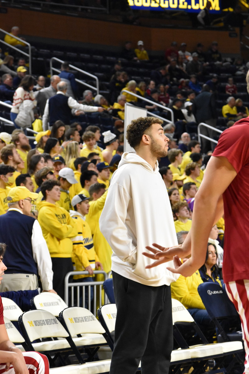 Race Thompson watched his teammates warm up for Indiana's game against Michigan. Thompson was held out of the game for precautionary measures.