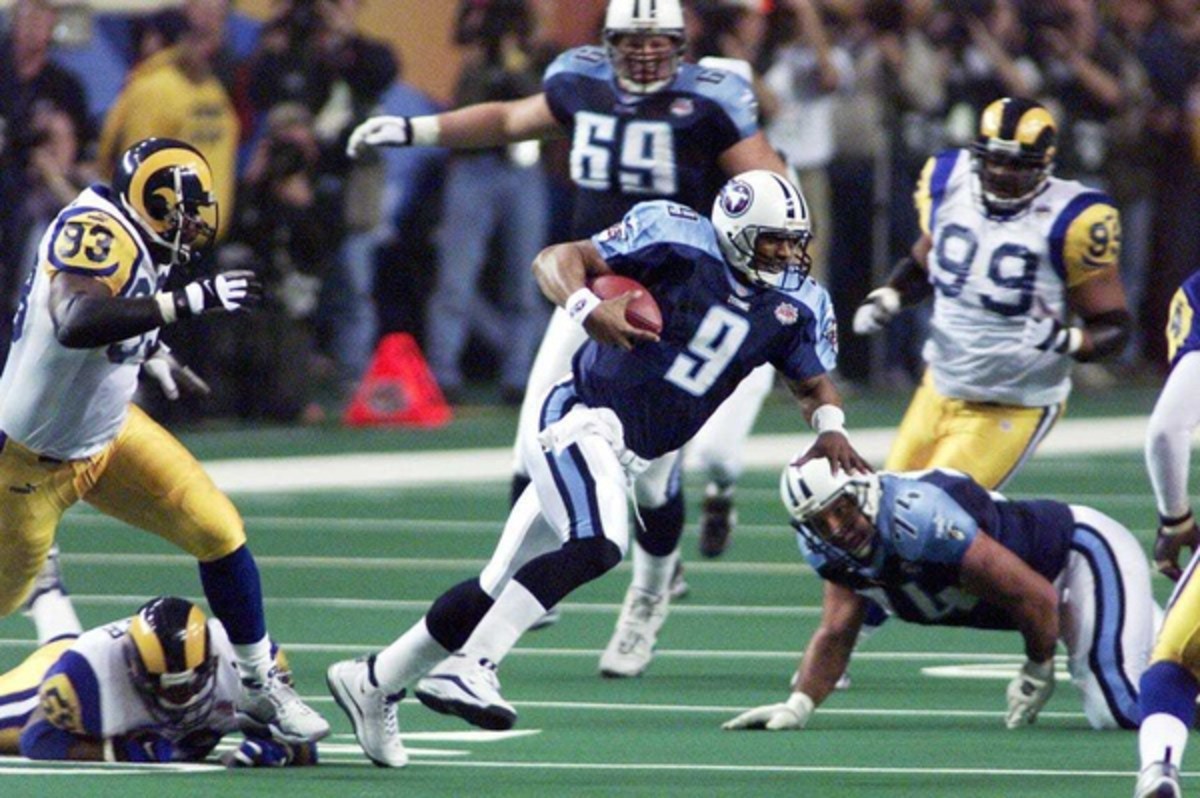 Tennessee Titans quarterback Steve McNair (9) takes off on a run to get away from St. Louis defensive end Kevin Carter (93) during the second quarter of Super Bowl XXXIV inside the Georgia Dome Jan. 30, 2000. Tennessee Titans Vs St Louis Rams In Super Bowl Xxxiv Football