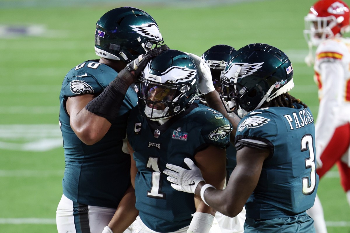 Eagles quarterback Jalen Hurts is congratulated by teammates after scoring a touchdown in the fourth quarter against the Chiefs in Super Bowl LVII.