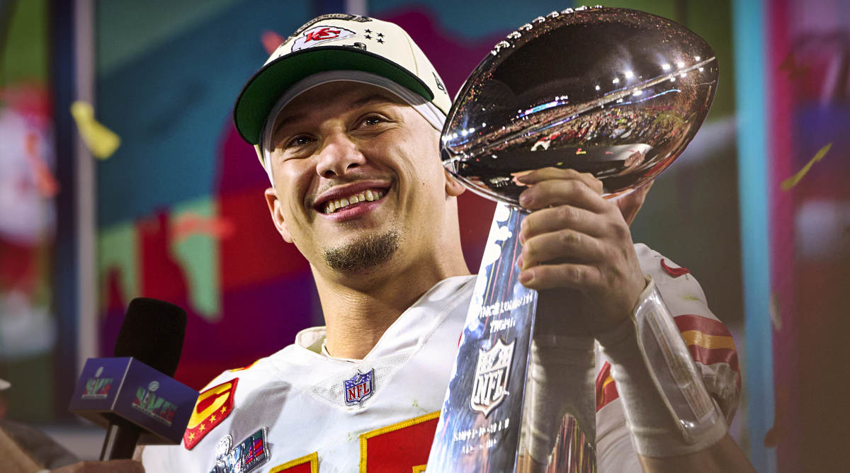 Patrick Mahomes smiles as he holds the Lombardi Trophy