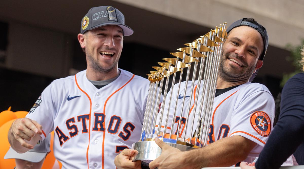 Nov 7, 2022; Houston Astros third baseman Alex Bregman (2) and second baseman Jose Altuve (27) celebrate with the 2022 Commissioner s Trophy in the Houston Astros Championship Parade in Houston, Texas, USA.