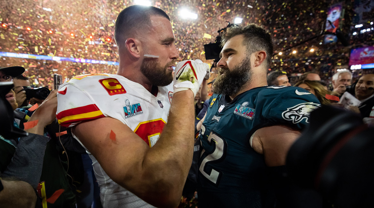 Chiefs tight end Travis Kelce (87) talks with his brother, Eagles center Jason Kelce (62) after Super Bowl LVII at State Farm Stadium