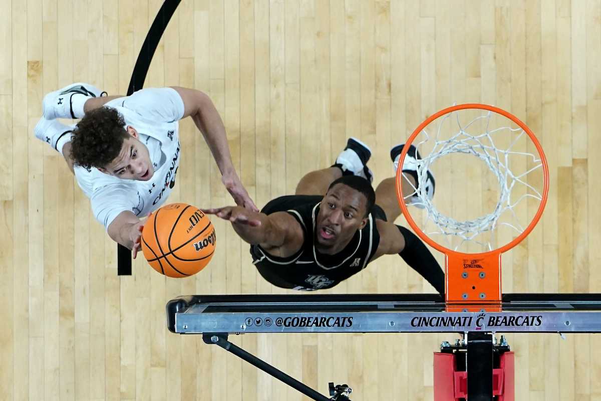 Cincinnati Bearcats guard Dan Skillings Jr. (0) rises to the basket as UCF Knights guard C.J. Kelly (13) defends in the first half of a college basketball game between the UCF Knights and the Cincinnati Bearcats, Saturday, Feb. 4, 2023, at Fifth Third Arena in Cincinnati. The Cincinnati Bearcats won, 73-64. Ucf Knights At Cincinnati Bearcats Feb 4 1196