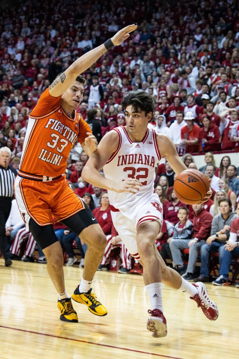 Indiana Hoosiers guard Trey Galloway (32) dribbles the ball while Illinois Fighting Illini forward Coleman Hawkins (33) defends in the first half at Simon Skjodt Assembly Hall.