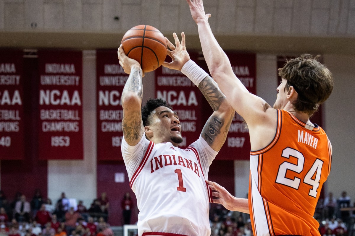 Jalen Hood-Schifino (1) shoots the ball while Illinois Fighting Illini forward Matthew Mayer (24) defends in the first half at Simon Skjodt Assembly Hall.